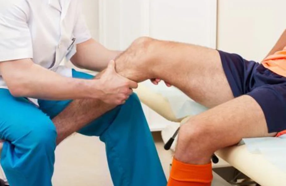 Healthcare professional examining patients elbow and arm during medical consultation